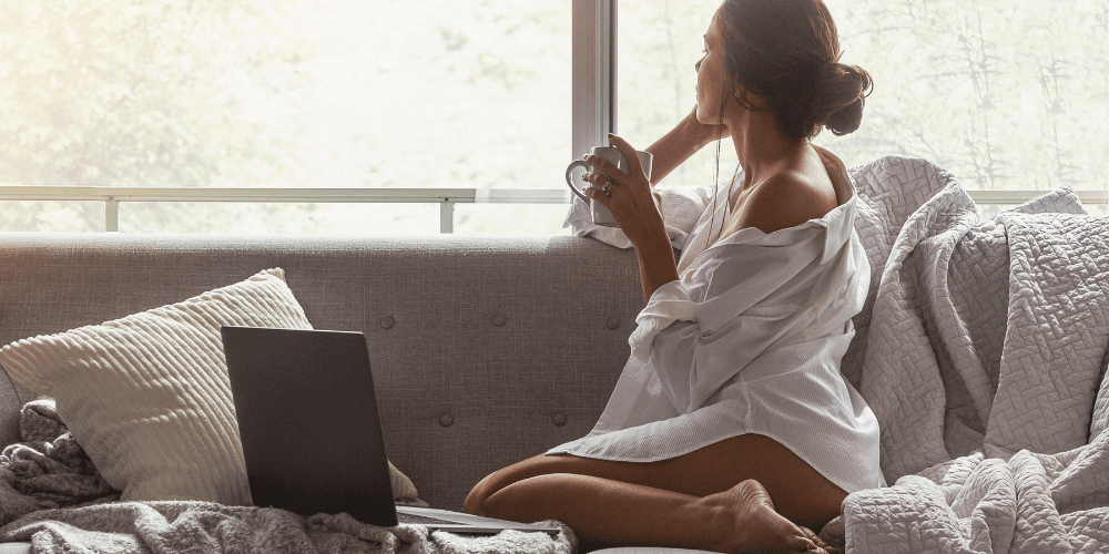 woman relaxing at home with a cup of coffee and feet up